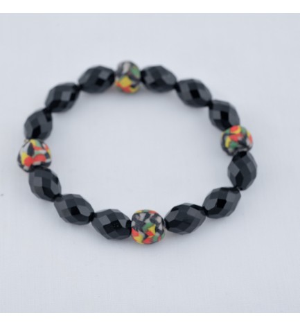 Adzo Designs bracelet with black glass bead and kente colour krobo beads on stretch